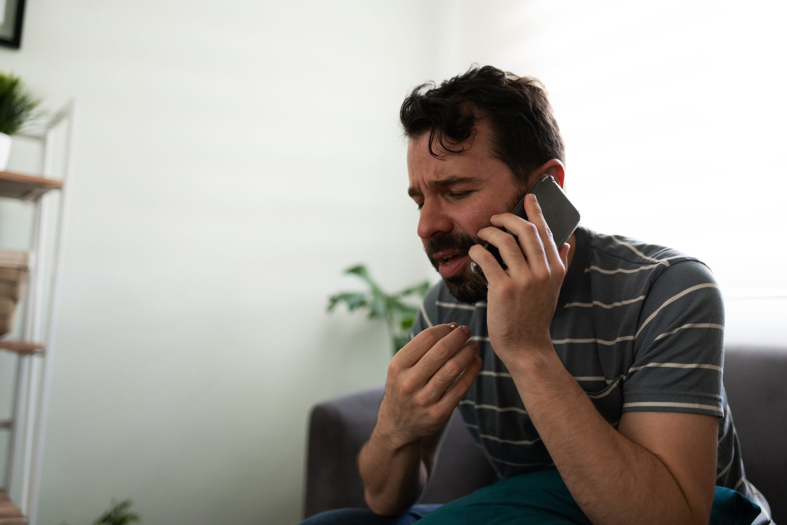 Man talking about his feelings on the phone