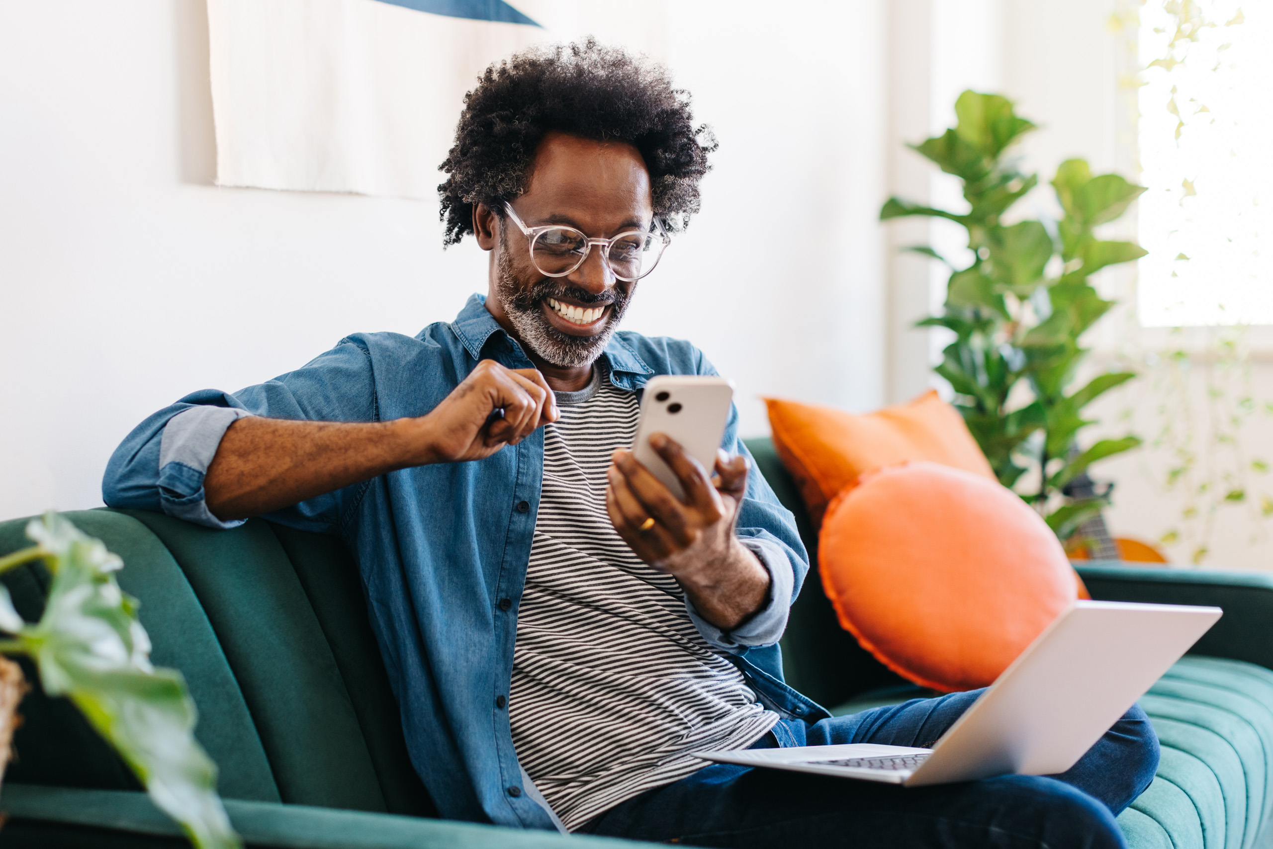 A middle-aged man happily engages with his phone due to a passionate call agent requesting donations for food charities
